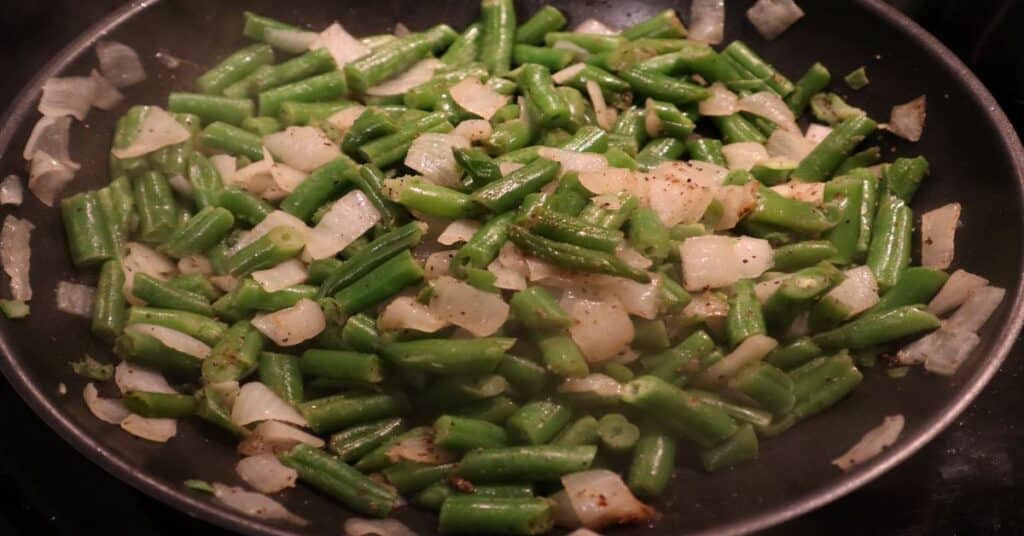 Sautee green beans with onions, garlic,