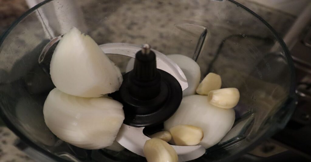 quartered onion and garlic cloves in a food processor before blending
