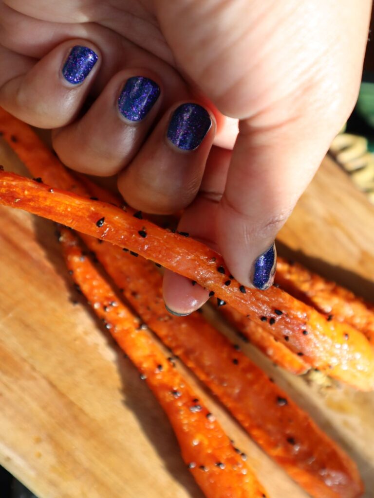 Holding Roasted Carrots with nigella seeds