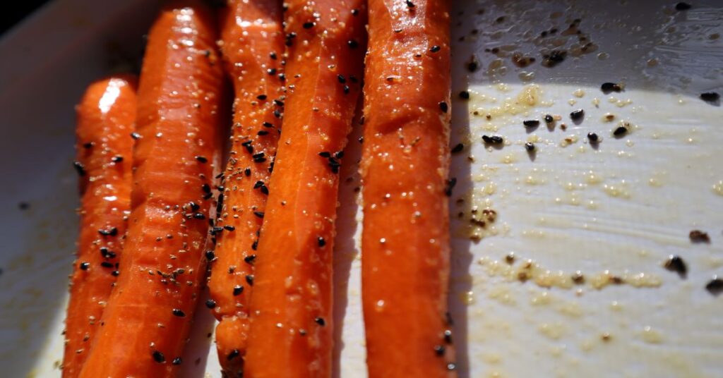 Roasted Carrots with nigella seeds in a white baking dish
