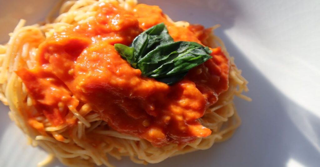 Angel Hair Pasta With Homemade Tomato Sauce topped with fresh basil 
