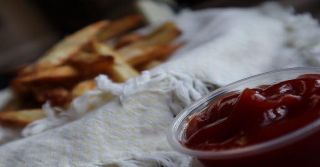 Crispy Homemade Air Fryer French Fries with ketchup ramekin nearby