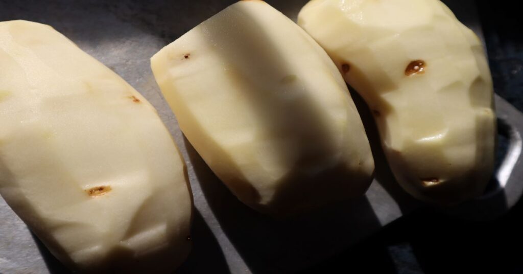 three raw potatoes peeled