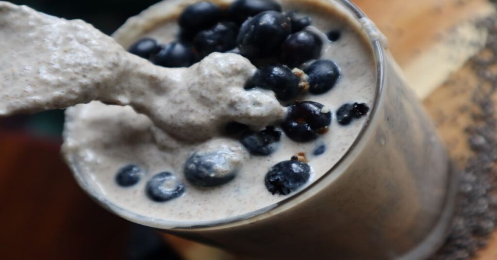 Creamy chia seed pudding over blueberries in the cup