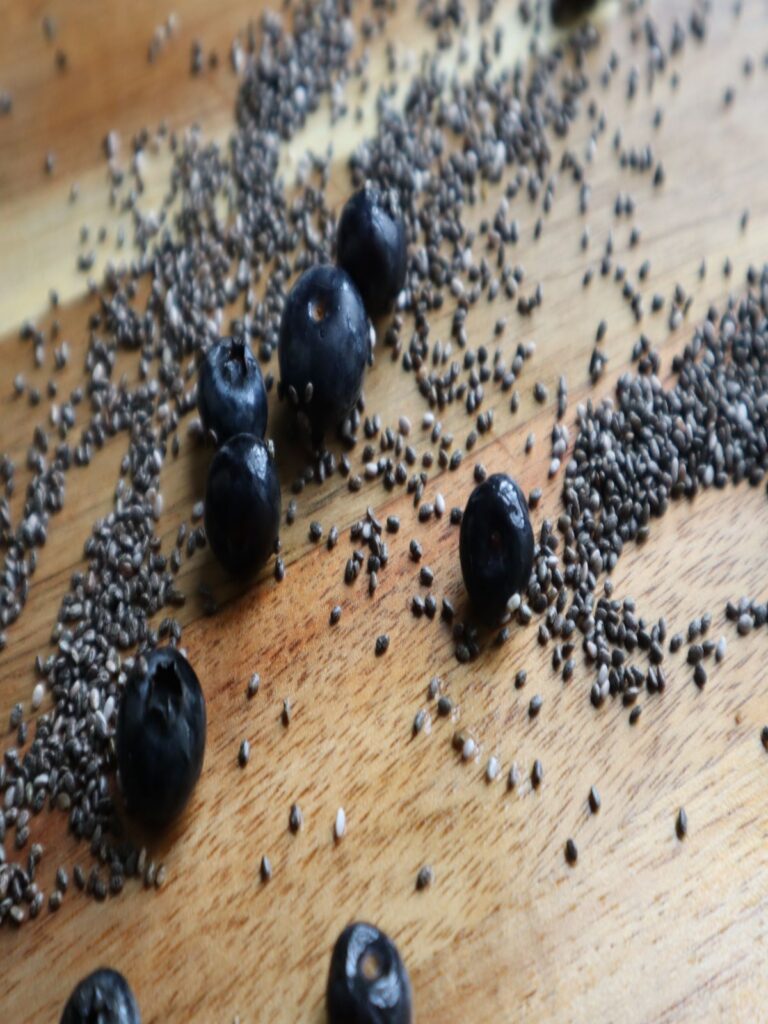 blueberries and chia seeds on a brown wooden board background
