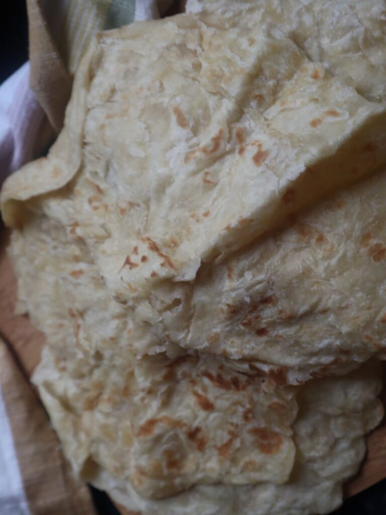 Finished Paratha Roti with a kitchen towel in background