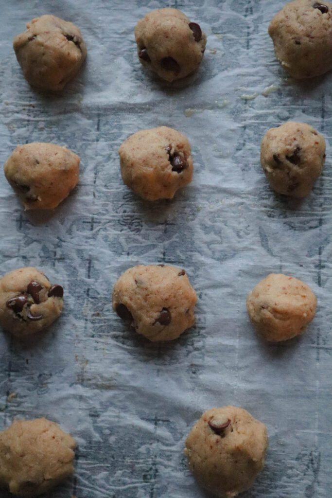 Vegan Banana Chocolate Chip Cookies in round balls on parchment paper