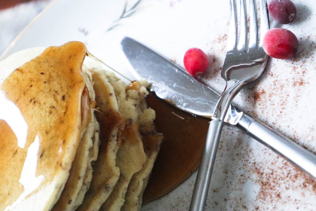 Stack of pancakes with knife and fork next to it