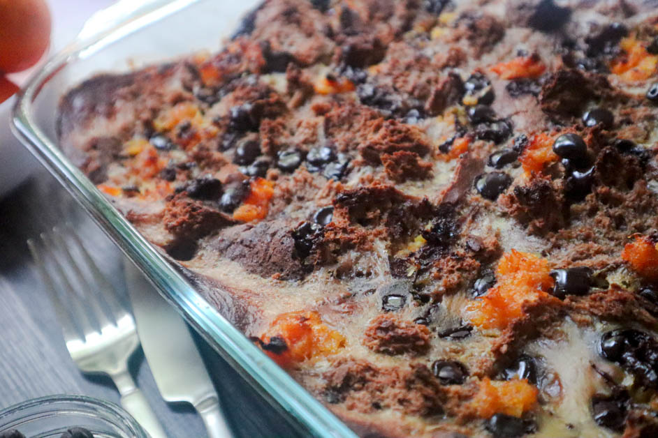Chocolate Orange Bread Pudding in casserole dish with knife and fork next to dish