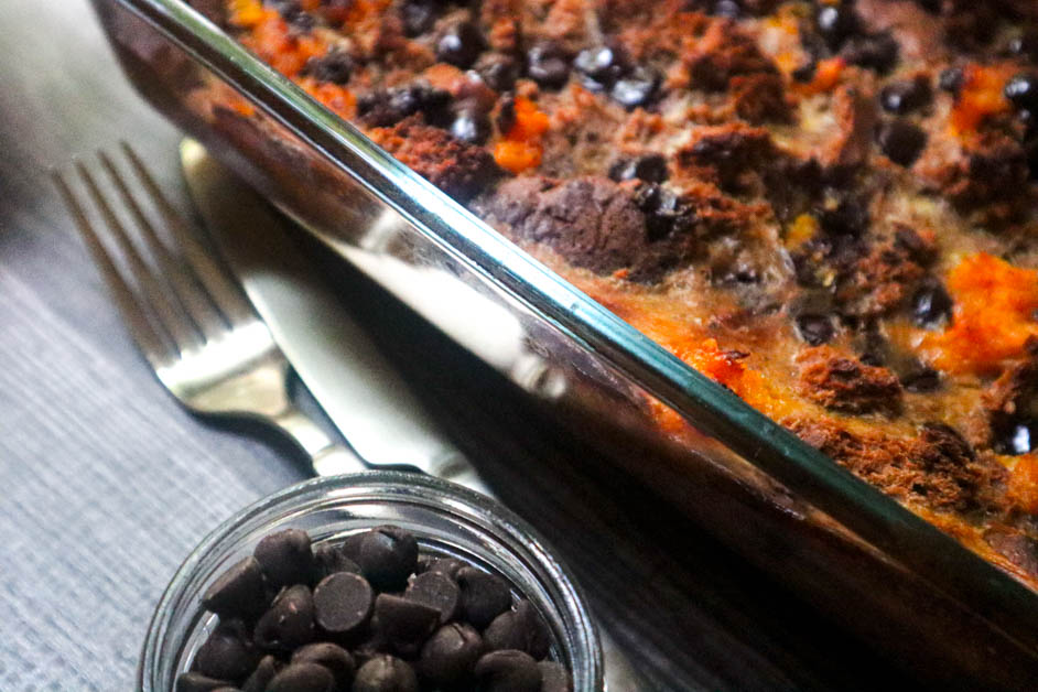 Chocolate Orange Bread Pudding in casserole dish with knife and fork next to dish