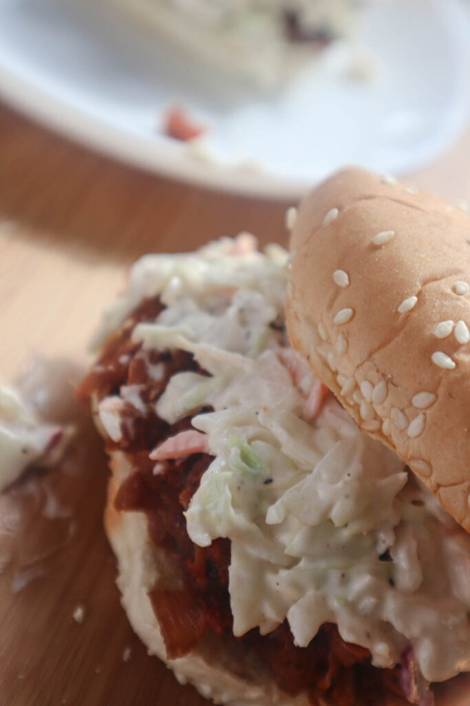 Pulled bbq jackfruit smothered in coleslaw on a sesame seed bun